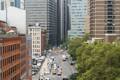 High angle view of traffic on road amidst buildings in city