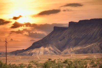 Scenic view of desert against sky during sunset