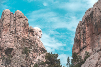 Low angle view of rock formation against sky