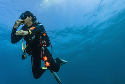 Female diver performing a safety stop in 5meters depth in australia