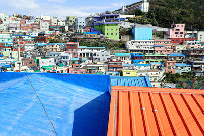 High angle view of buildings against blue sky