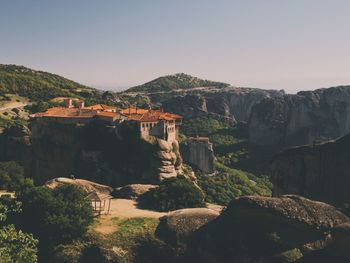 Scenic view of mountains and monastery against clear sky