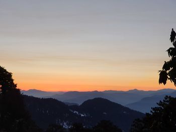 Scenic view of silhouette mountains against sky at sunset