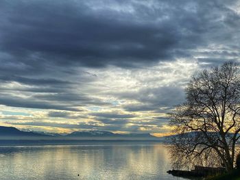 Scenic view of lake against sky at sunset