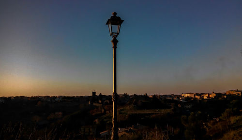 View of street light against sky at sunset