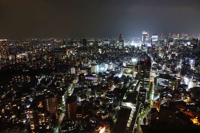 High angle view of illuminated city buildings at night