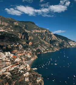 High angle view of townscape by sea against sky