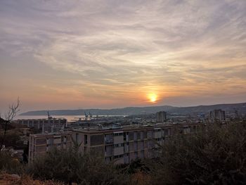 High angle view of buildings against sky during sunset