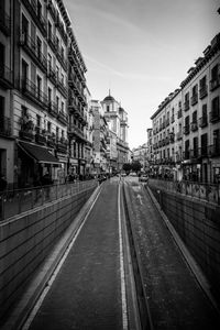 Street amidst buildings in city against sky