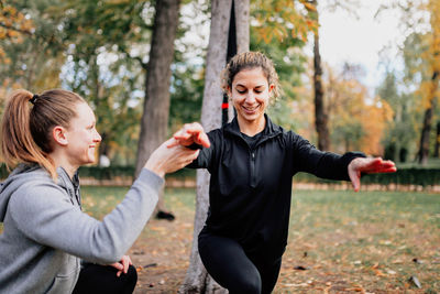 Close-up of women exercising at park