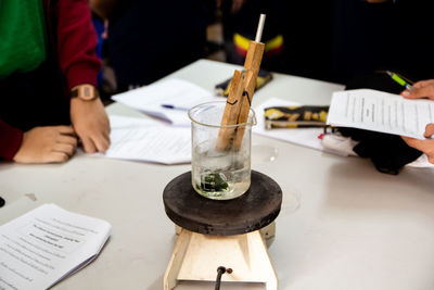 High angle view of hand holding book on table