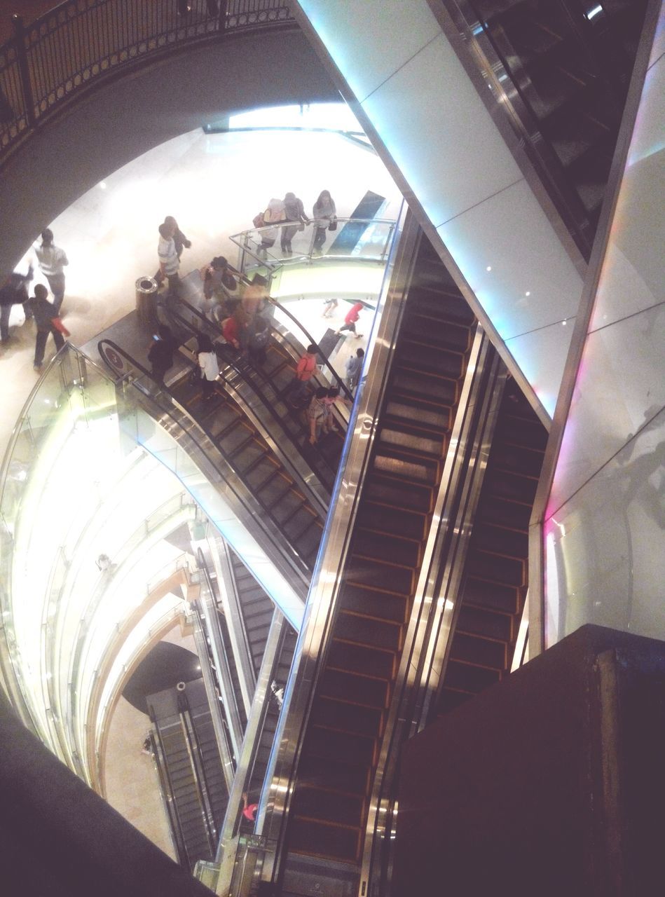 indoors, architecture, built structure, steps, steps and staircases, staircase, high angle view, building exterior, low angle view, men, ceiling, lifestyles, railing, incidental people, building, illuminated, person, travel, interior