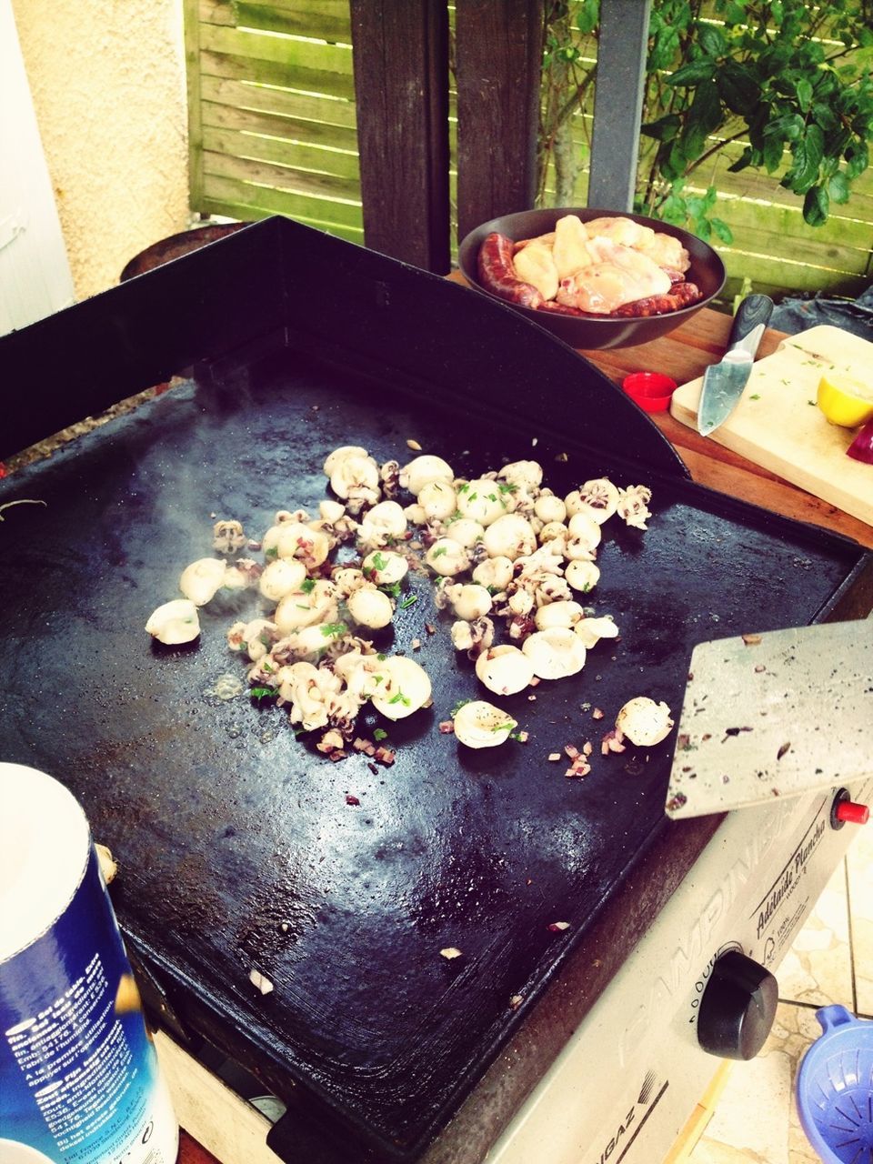 food and drink, freshness, food, high angle view, healthy eating, table, leaf, person, indoors, ready-to-eat, meat, preparation, day, part of, unrecognizable person, preparing food, close-up