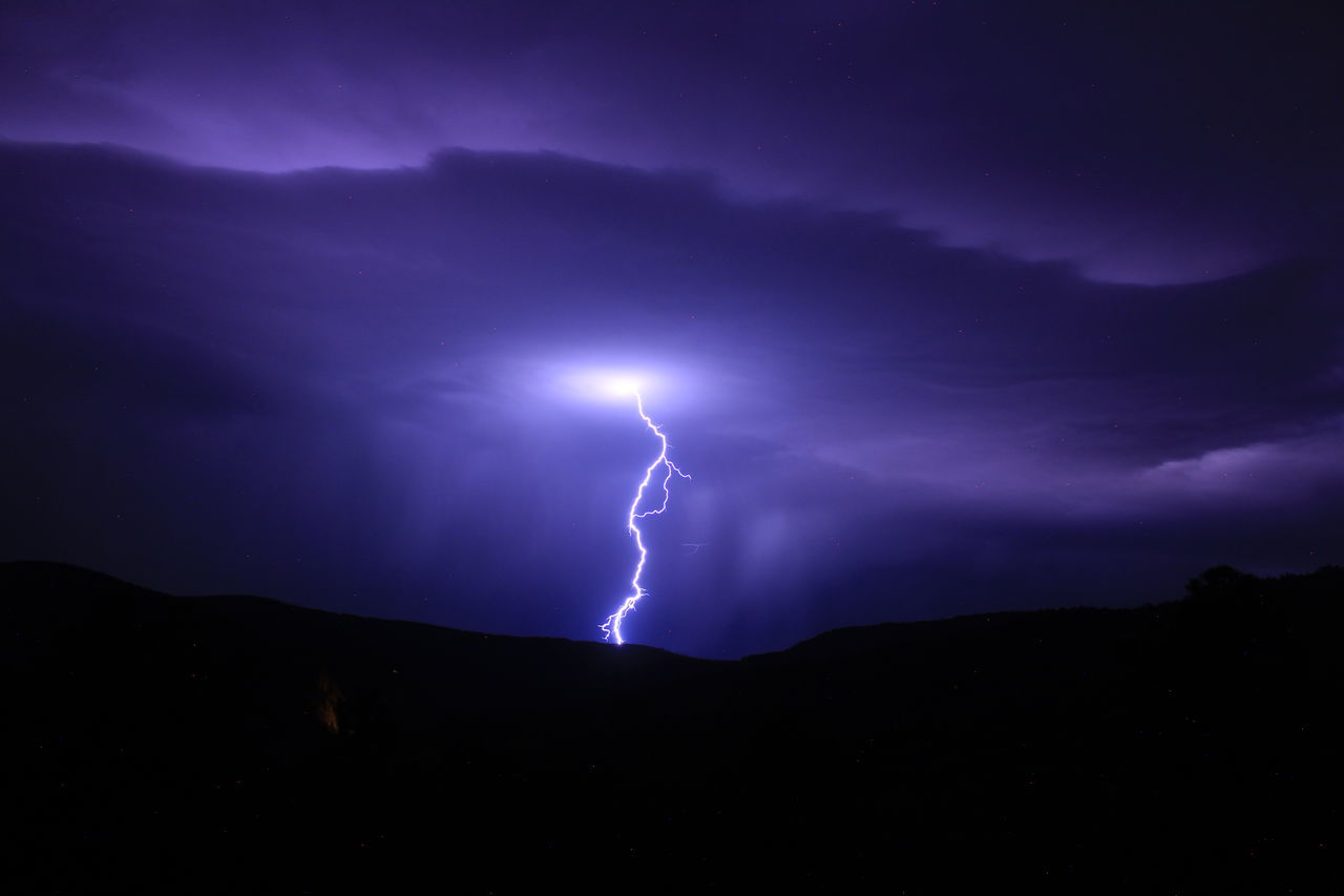 lightning, power in nature, storm, thunderstorm, cloud, beauty in nature, warning sign, sky, thunder, night, forked lightning, dramatic sky, sign, storm cloud, environment, communication, electricity, nature, bolt, purple, scenics - nature, no people, darkness, mountain, extreme weather, outdoors, dark, awe, light - natural phenomenon, overcast, atmospheric mood, illuminated, rain, wet, meteorology, silhouette