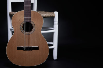 Close-up of guitar against black background