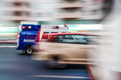 Blurred motion of ambulance on road