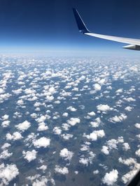 Aerial view of airplane wing against sky