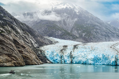 Scenic view of lake and mountains against sky at the dawes glacier in alaska 