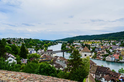 High angle view of houses in town against sky