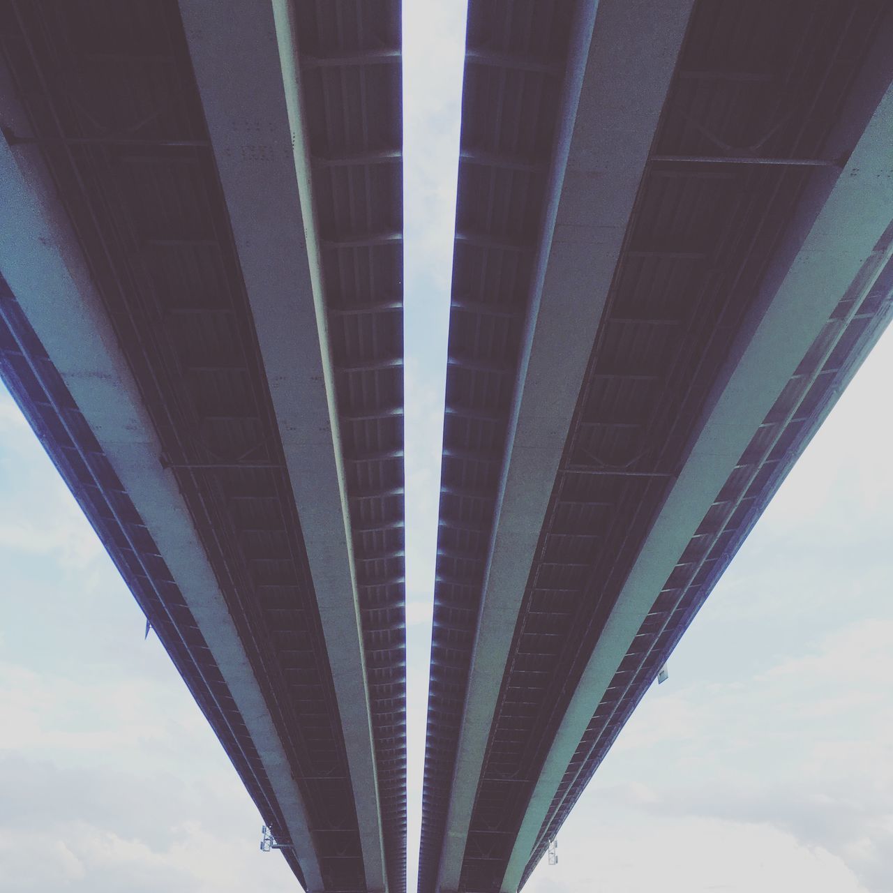 LOW ANGLE VIEW OF BRIDGE AGAINST CLOUDY SKY