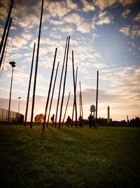 Scenic view of grassy field against cloudy sky