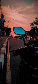 Vehicles on road at sunset