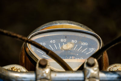 Close-up of abandoned bike against black background