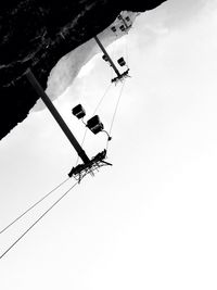 Low angle view of ski lift against sky