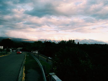 Country road against cloudy sky
