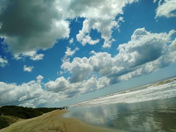 Aerial view of sea against cloudy sky