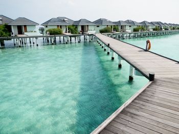 Swimming pool by sea against sky