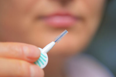 Cropped image of woman holding eyelash brush