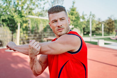 Portrait of young man exercising in gym