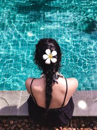 High angle view of woman relaxing in swimming pool