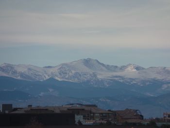 Houses and mountains against sky