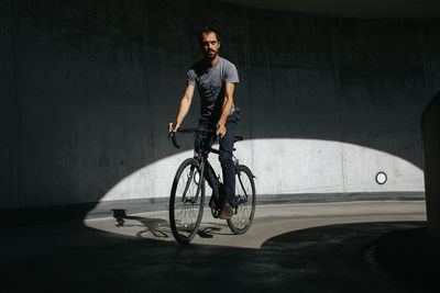 Young man riding bicycle