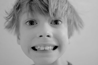 Close-up portrait of boy clenching teeth
