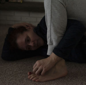 Portrait of boy lying on floor at home