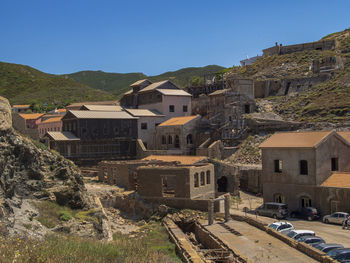 Houses in town against clear blue sky