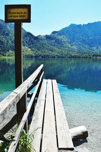 Scenic view of lake by mountains against sky