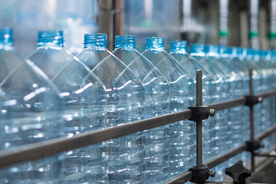 Empty blue five-liter plastic bottles on a conveyor belt. automated production of drinking water