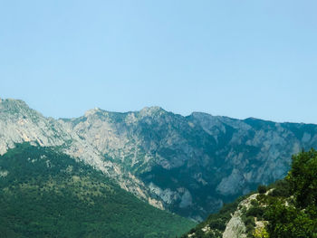 Scenic view of mountains against clear blue sky