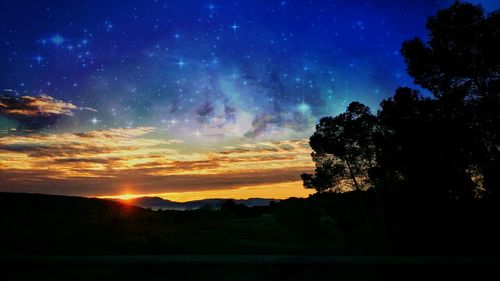 Scenic view of silhouette landscape against sky at night