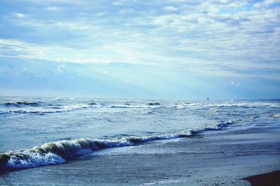 Scenic view of sea against cloudy sky