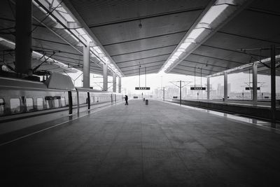 Rear view of woman walking in corridor