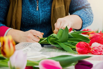 Midsection of woman holding bouquet