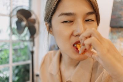 Portrait of young woman drinking glass