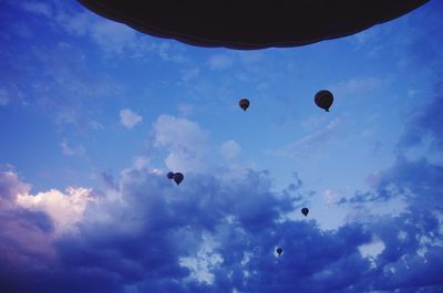 Low angle view of hot air balloons against blue sky