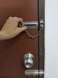 Cropped hand locking door