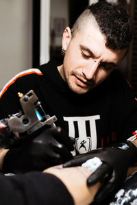 Portrait of young man using mobile phone at home